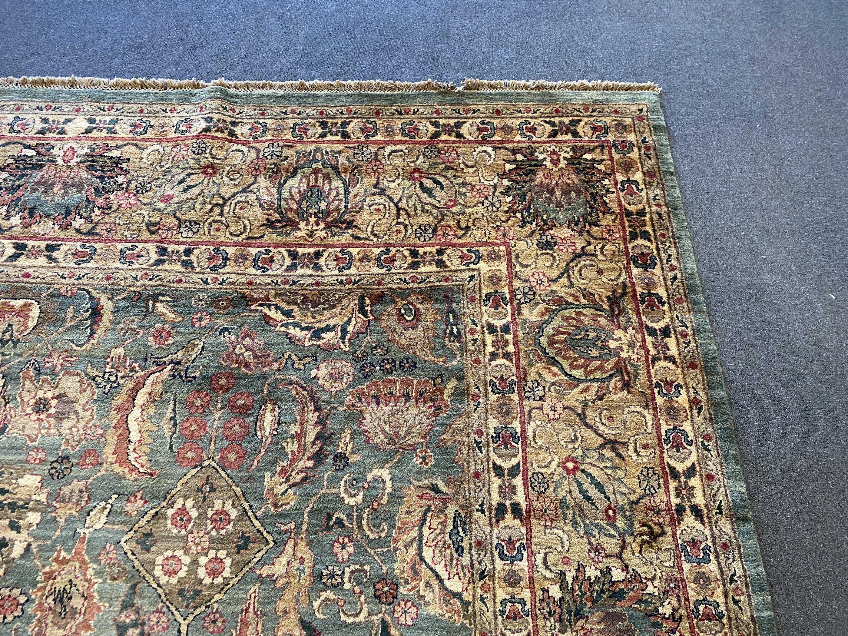 An Indian Persian style sage green ground carpet, 465 x 363cm